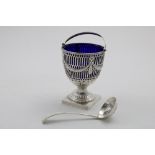 AN EDWARDIAN SWING-HANDLED SUGAR BASKET with a blue glass liner, by Carrington and Co., London