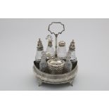 A GEORGE III BOAT-SHAPED CRUET FRAME with engraved decoration and an inset wooden base, crested,