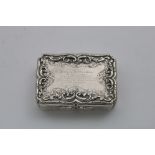 AN EARLY VICTORIAN ENGRAVED SNUFF BOX of rectangular serpentine outline with applied scroll
