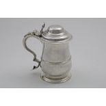 A GEORGE III BALUSTER TANKARD on a spreading foot with an applied moulded girdle, domed cover and