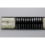 A 20TH CENTURY SET OF TWELVE HORS-D'OEUVRE FORKS with playing card terminals, representing the