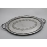 A LATE VICTORIAN ELECTROPLATED, TWO-HANDLED OVAL TRAY with a part-fluted border and stamped floral