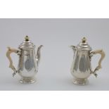 A PAIR OF EARLY 20TH CENTURY CAFE AU LAIT POTS with baluster bodies, ivory scroll handles & ivory