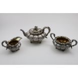 A GEORGE IV EMBOSSED THREE-PIECE TEA SET with squat, lobed, circular bodies on leafy husk feet, with