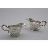 A PAIR OF EARLY 20TH CENTURY SAUCE BOATS in the early George II style with stepped oval bases,