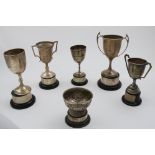 AN EMBOSSED BOWL AND FOUR TROPHY CUPS each inscribed and relating to the Axminster and District