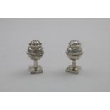 A PAIR OF EARLY 20TH CENTURY SCOTTISH PEPPER CASTERS on square pedestal bases, with spherical