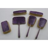 AN ART DECO SIX-PIECE DRESSING TABLE SET decorated with translucent, amethyst-coloured enamel over
