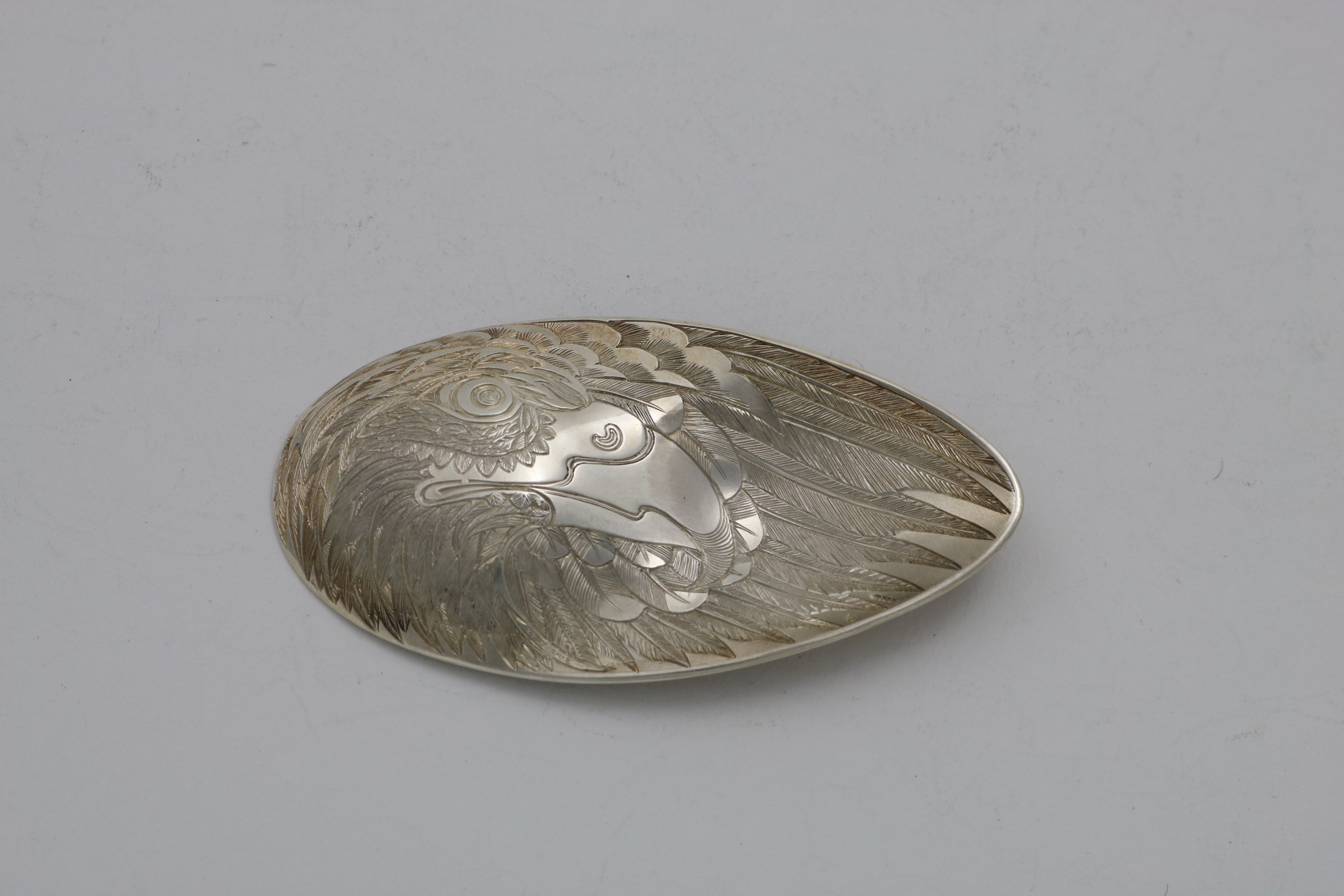 A CONTEMPORARY DOUBLE-SIDED CADDY SPOON engraved to resemble a stylised eagle's wing form made by