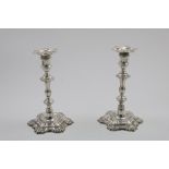 A PAIR OF GEORGE II CAST CANDLESTICKS on hexafoil bases with shell decoration, knopped and