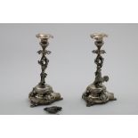 A PAIR OF LATE 19TH CENTURY PORTUGUESE CANDLESTICKS on shaped bases with applied cartouches, the