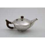 A LATE 20TH CENTURY HANDMADE CIRCULAR TEA POT with a hammered finish, a shaped frieze around the