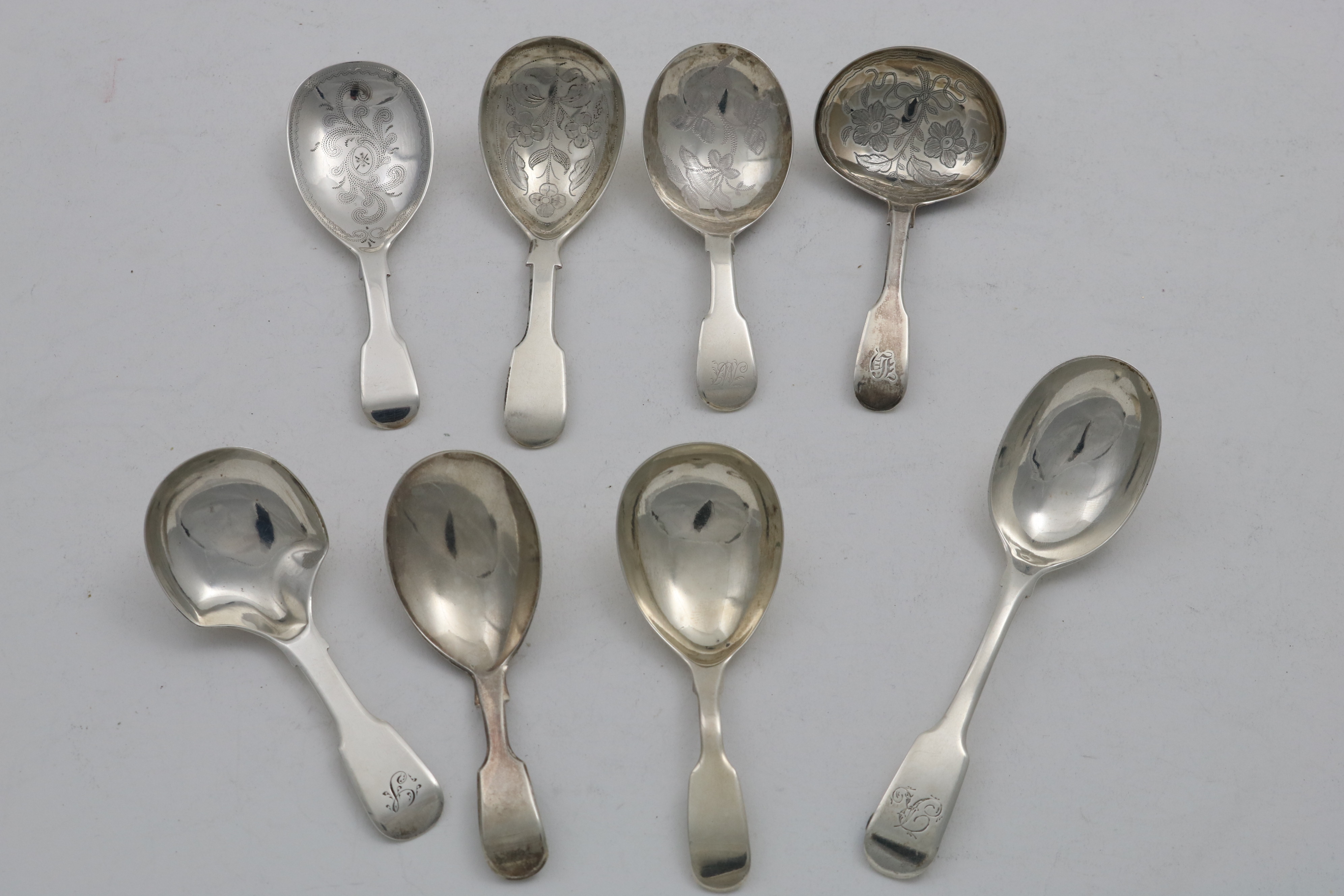 FOUR ANTIQUE FIDDLE PATTERN CADDY SPOONS with engraved bowls and four other Fiddle pattern caddy