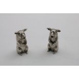 A PAIR OF 20TH CENTURY CAST NOVELTY PIG CONDIMENTS each sitting upright on its haunches (one for