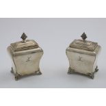 A PAIR OF EARLY VICTORIAN TEA CADDIES of plain bombe form on scroll feet, with lift-off covers and