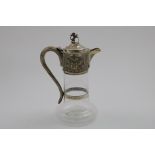 A VICTORIAN MOUNTED CLEAR GLASS CLARET JUG with a baluster body and a star-cut base, the mount