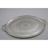 A VICTORIAN ENGRAVED TWO-HANDLED OVAL TRAY with a reeded border, engraved in the centre with coat of