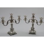 A PAIR OF SCANDINAVIAN THREE-LIGHT CANDELABRA on lobed and shaped square bases with scroll