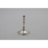 A MID 20TH CENTURY CAST TAPERSTICK on a faceted octagonal base with a baluster octagonal column,