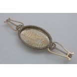 A GEORGE IV SCOTTISH LEMON STRAINER (for punch bowl) with twin lyre and shell handles and an oval