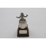 AN EARLY 20TH CENTURY SMALL CAST FIGURAL BELL in the form of a young lady in a crinoline dress and