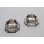 A PAIR OF GEORGE II TRENCHER SALTS square with incurved corners and moulded, waisted sides,