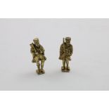 A PAIR OF LATE 17TH CENTURY SMALL SILVERGILT FIGURES each carrying an orb and a symbol (a sword &