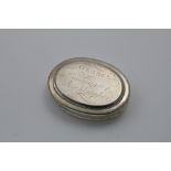 A GEORGE I OVAL TOBACCO BOX with moulded borders and a pull-off cover, inscribed "GEORGE-