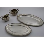 A GRADUATED PAIR OF GEORGE V MEAT DISHES of shaped oval outline with gadrooned borders by Mappin &