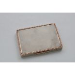 AN EARLY 20TH CENTURY ENGINE-TURNED BOX rectangular with a flush hinge and rose-gold border and
