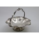 A LATE PERIOD OLD SHEFFIELD PLATED CAKE BASKET of shaped circular outline with a swing handle, a