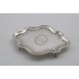 A RARE GEORGE III ENGRAVED TEAPOT STAND with a serpentine outline, engraved crests and motto, by