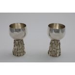 A PAIR OF LATE 20TH CENTURY HANDMADE WINE GOBLETS on conical, textured stems with assorted,