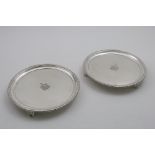 A PAIR OF GEORGE III CIRCULAR SALVERS with gadrooned borders and gadrooned bracket feet, engraved in