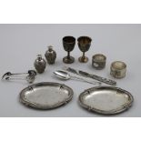 CHINESE SILVER:- A pair of sugar tongs, two egg cups, two napkin rings, a pair of pepper casters,