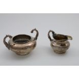 A WILLIAM IV IRISH CIRCULAR CREAM JUG & MATCHING SUGAR BOWL plain, with circular bases and upswept