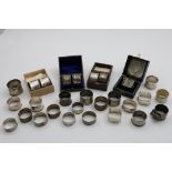 NAPKIN RINGS:- A single napkin ring (boxed), a cased pair of pierced napkin rings, initialled, a