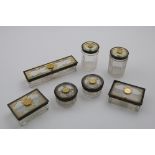 AN EARLY VICTORIAN SET OF SEVEN PARCELGILT MOUNTED TOILET BOXES/JARS each with a circular gold