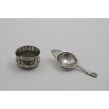 BY R.E. STONE:- A mid-20th century handmade tea strainer, decorated with briar roses, and matching