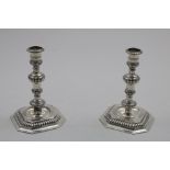 A PAIR OF LATE 20TH CENTURY CAST CANDLESTICKS in the William & Mary style on canted square bases, by