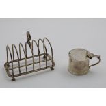 A LATE VICTORIAN TOAST RACK with seven arched bars and four feet, by William Hutton & Sons, London