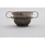 A QUEEN ANNE MINIATURE OR TOY PORRINGER with part-fluting and two S-scroll handles, by Nathaniel