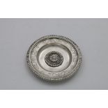 AN EARLY 18TH CENTURY GERMAN SMALL DISH circular with a gadrooned rim, chased border decoration