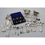 A MIXED LOT:- Two sauce boats, a cased set of six coffee spoons, a pair of filigree sugar tongs,