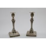 A PAIR OF LATE VICTORIAN CANDLESTICKS in the Neo Classical taste with canted square bases, decorated