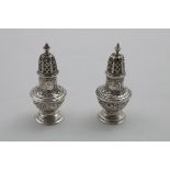 A PAIR OF GEORGE IV / WILLIAM IV VASE-SHAPED PEPPERETTES with chased decoration, the covers with