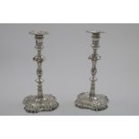 A PAIR OF GEORGE II/III CAST CANDLESTICKS on shaped square bases, with knopped and shouldered