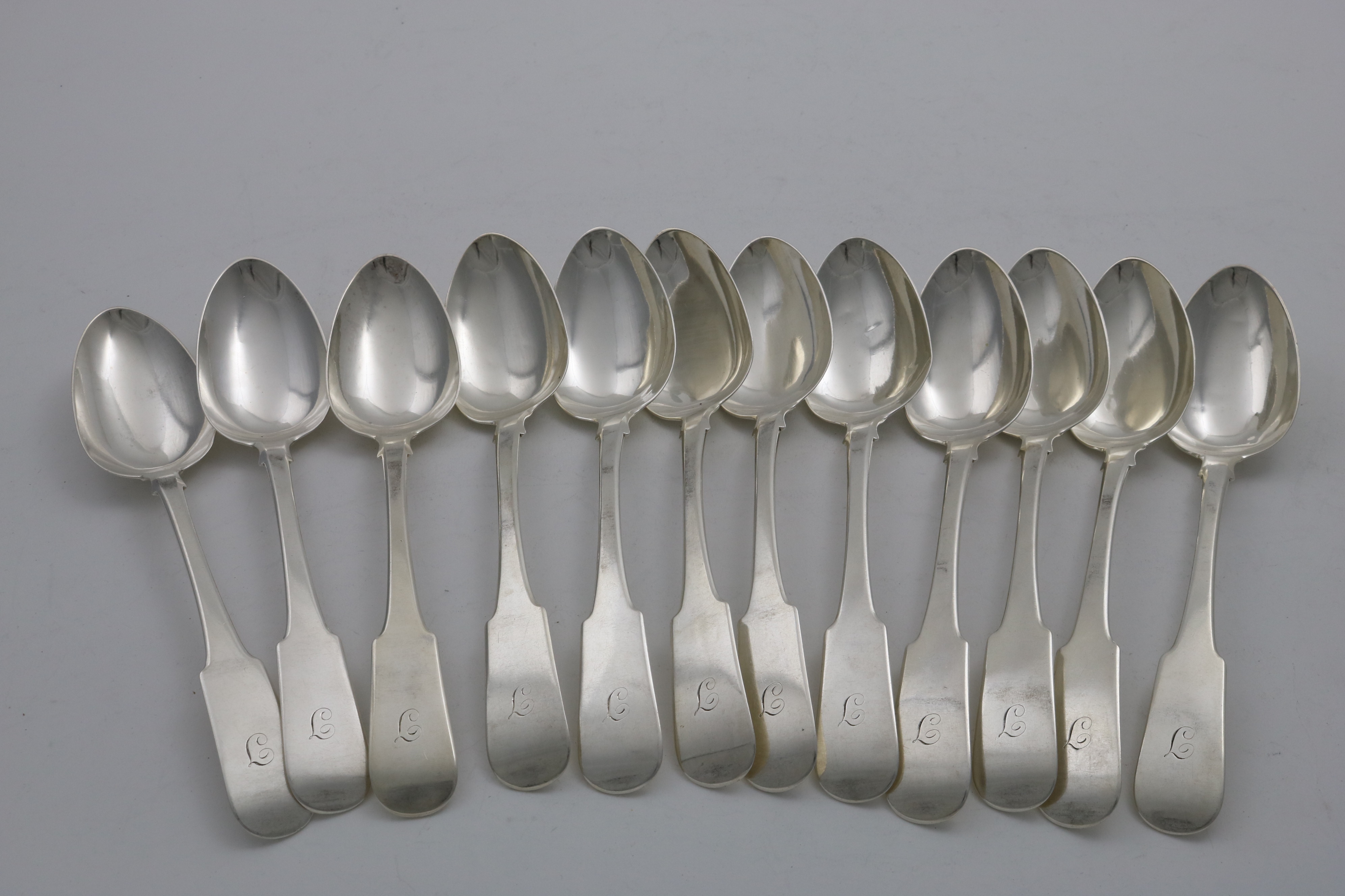 A SET OF TWELVE GEORGE IV SCOTTISH FIDDLE PATTERN TABLE SPOONS initialled "J", by Alexander