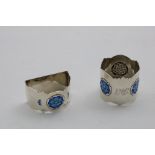 TWO EDWARDIAN NAPKIN RINGS each decorated with shaded blue enamel briar rose flowers (one