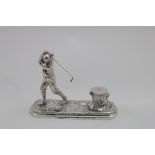 GOLFING:- A late Victorian cast inkstand in the form of a golfer on a rounded oblong base, about